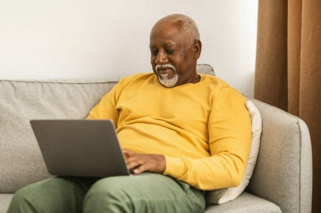 Adult man listening to audio description on landing page.