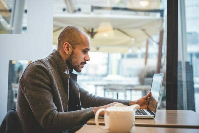 Business Ceo researching B2B website strategy over coffee.