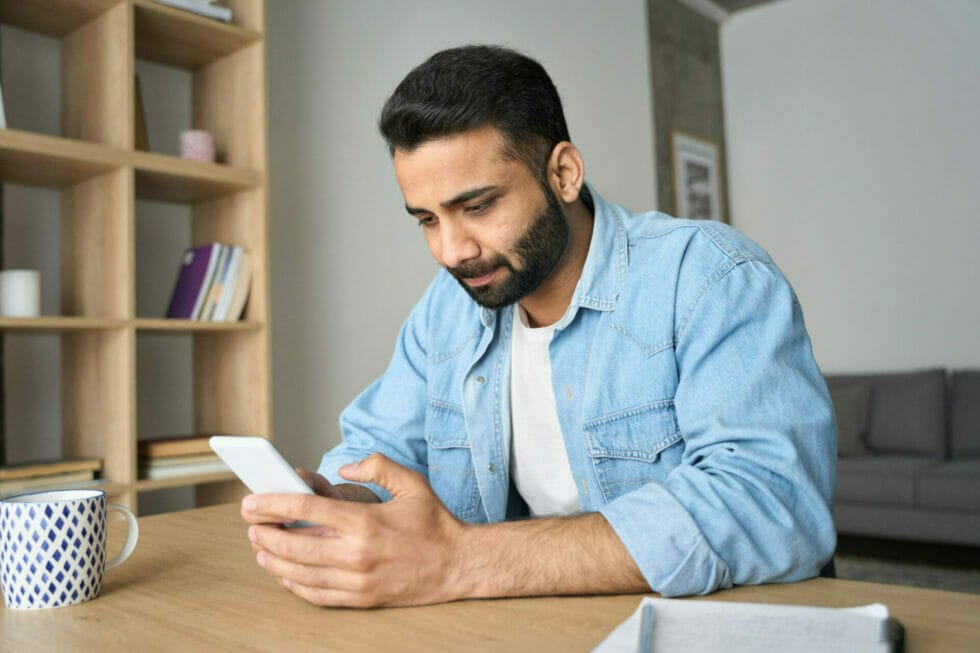 Young business person viewing multilingual website via mobile device.