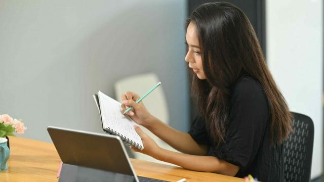 Female business person practicing sales presentation.